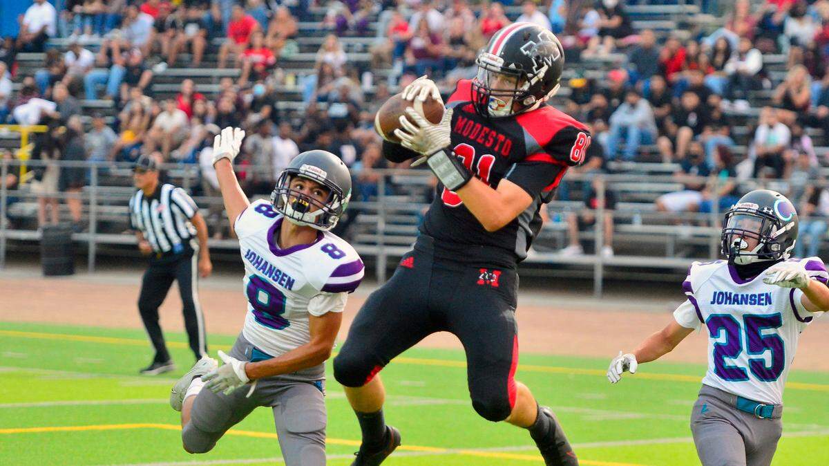 Modesto High receiver Heston Blom leaps to make a catch for a touchdown during a football game between Modesto High School and Johansen High School at Downey High School in Modesto California on August 20, 2021.