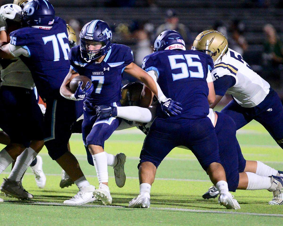 Downey running back Elijah Tamayo (7) breaks through the line during a game between Downey High School and Elk Grove High School at Downey High School in Modesto, Calif. on August 30, 2024.