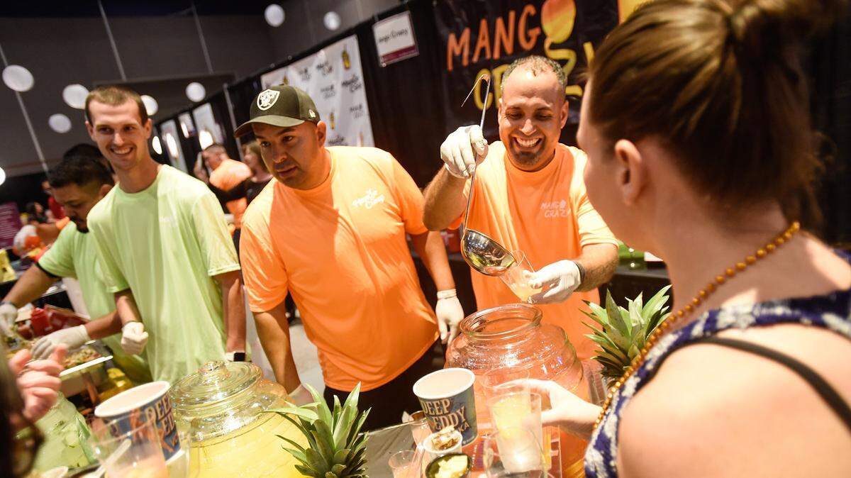 The Center for Human Services on Wednesday canceled its in-person Edible Extravaganza event. Pictured is Henry Valencia from Mango Crazy serving up fruit drinks for Crystal Cembran during the 2017 Edible Extravaganza at Modesto Centre Plaza.