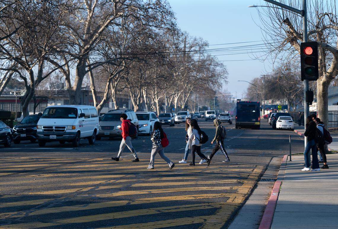 Modesto High School students walk to class across Paradise Road in Modesto in 2023.
