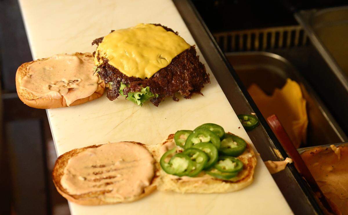 Burgers are assembled at Smash Bros Burgers in Merced, Calif., Tuesday, March 25, 2025.