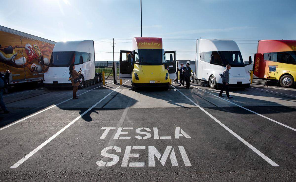 Tesla semi trucks recharge at a charging station at the Frito-Lay production facility in Modesto, Calif., Wednesday, Jan. 18, 2023. Frito-Lay introduced the Tesla semi trucks and the company’s other zero or near-zero emissions vehicles as part of its sustainability project at their Modesto plant.