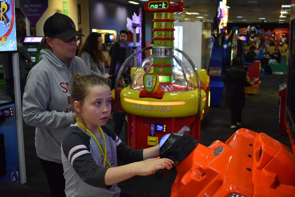 Amber Mello watches daughter Harper, 9, play a racing game during Sensory Sensitive Sunday the morning of March 3, 2019, at the Chuck E. Cheese’s on Sisk Road in Modesto.