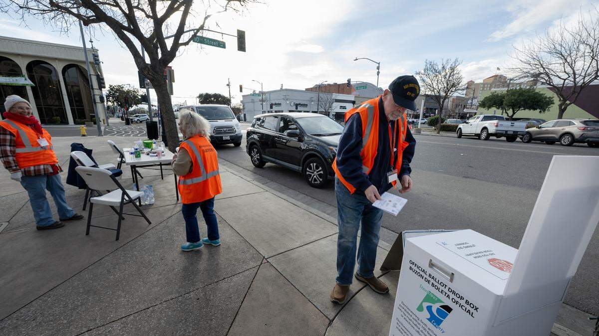 Election officer Robert Muse handles ballots at a drive-up ballot drop station outside the Gallo Center for the Arts in Modesto, Calif., Tuesday, March 5, 2024.