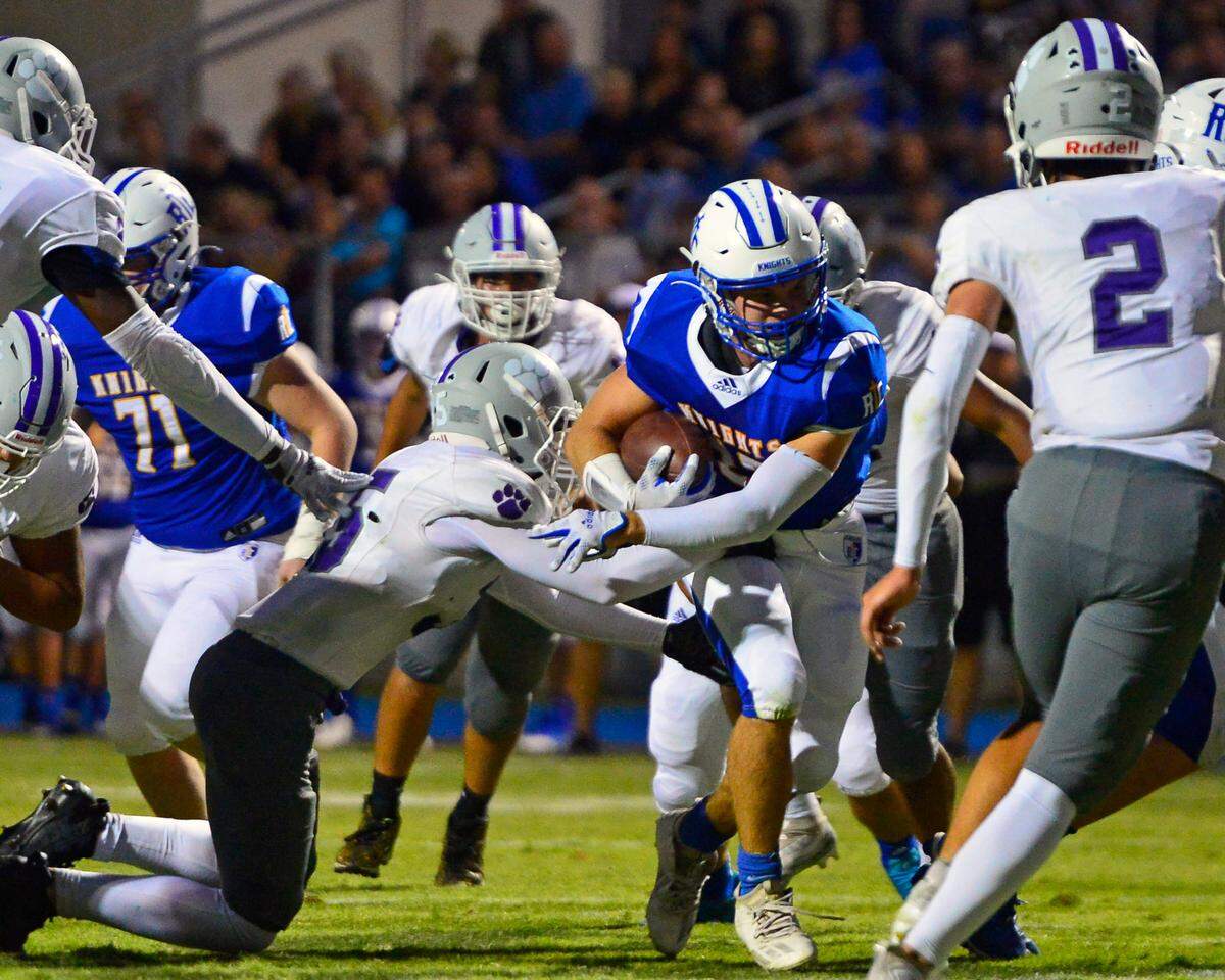RC running back Grant Sonke runs through defenders during a game between Ripon Christian and Denair at Ripon Christian High School in Ripon California on September 16, 2022.