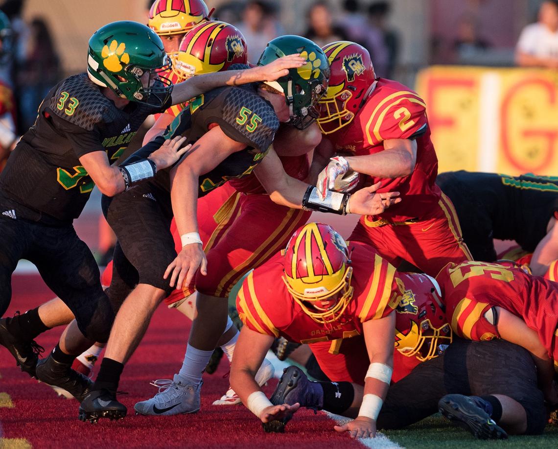 Oakdale’s Caleb Kuppens (2) pushes across the goal line for a touchdown during the non-conference league game with Sonora in Oakdale, Calif., Friday, August 17, 2018.