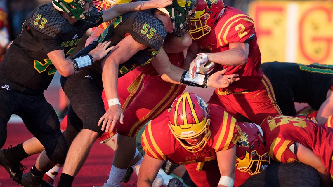 Oakdale’s Caleb Kuppens (2) pushes across the goal line for a touchdown during the non-conference league game with Sonora in Oakdale, Calif., Friday, August 17, 2018.