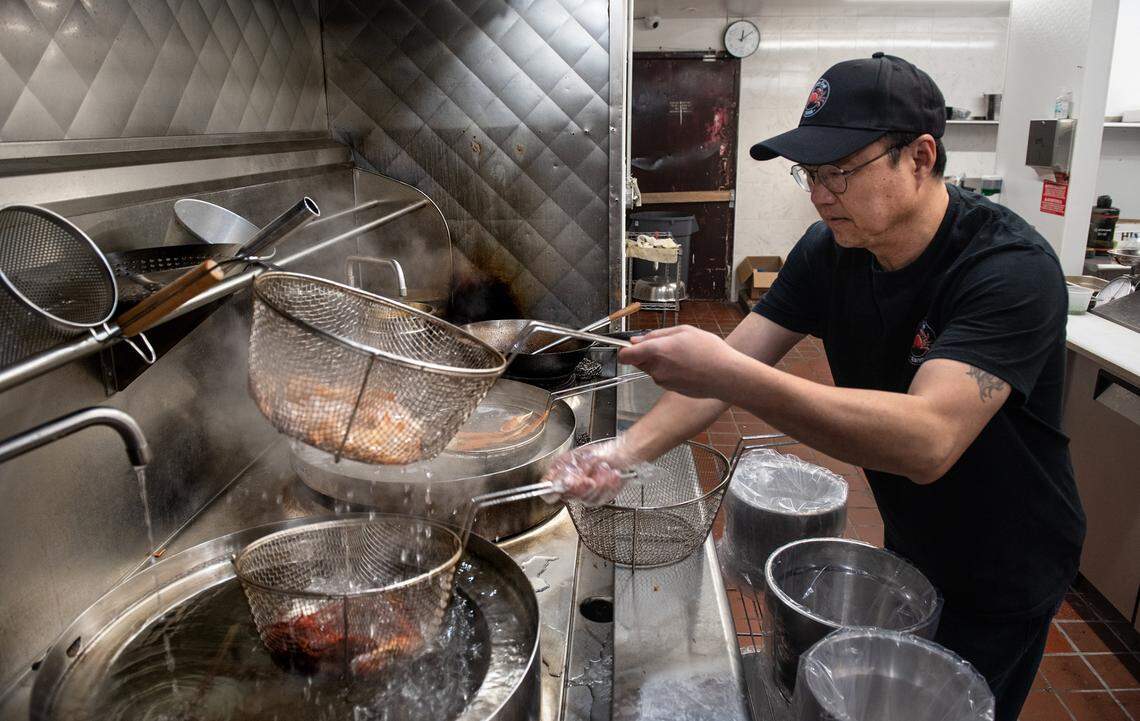 Owner Kevin Lin prepares a seafood combo at Akitaca Crab seafood restaurant in Modesto, Calif., on Wednesday, March 16, 2022.
