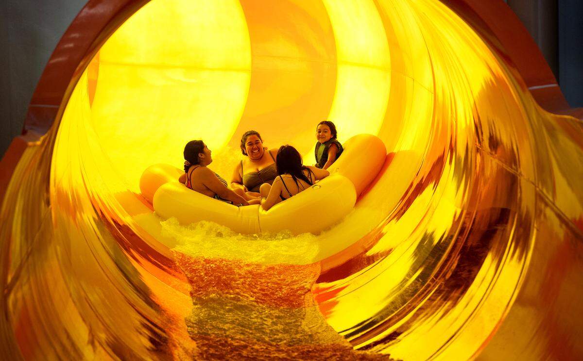Guests ride the Rapid Racer water slide at Great Wolf Lodge resort in Manteca, Calif., on Tuesday, June 29, 2021.
