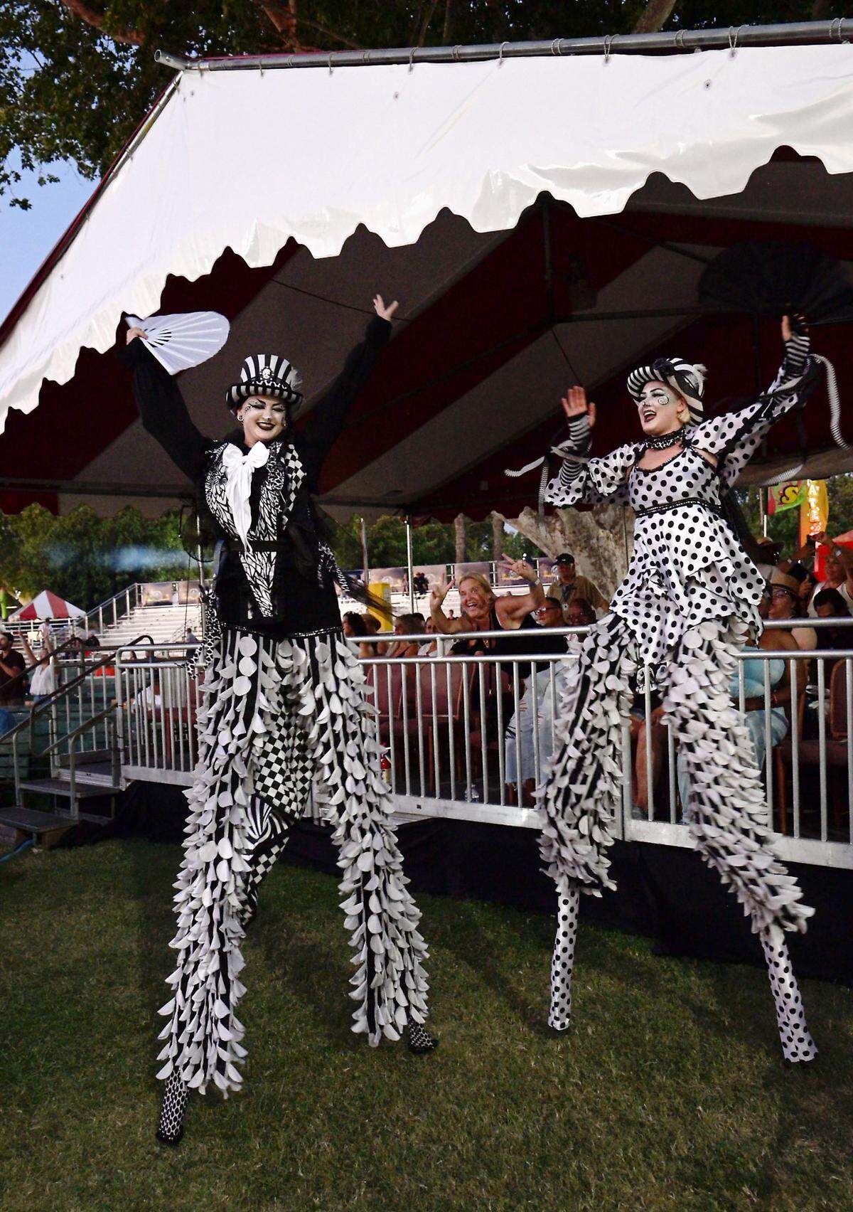 Members of the stilt circus dance to the band Con Funk Shun at the Stanislaus County Fair in Turlock, Monday, July 14, 2025. 