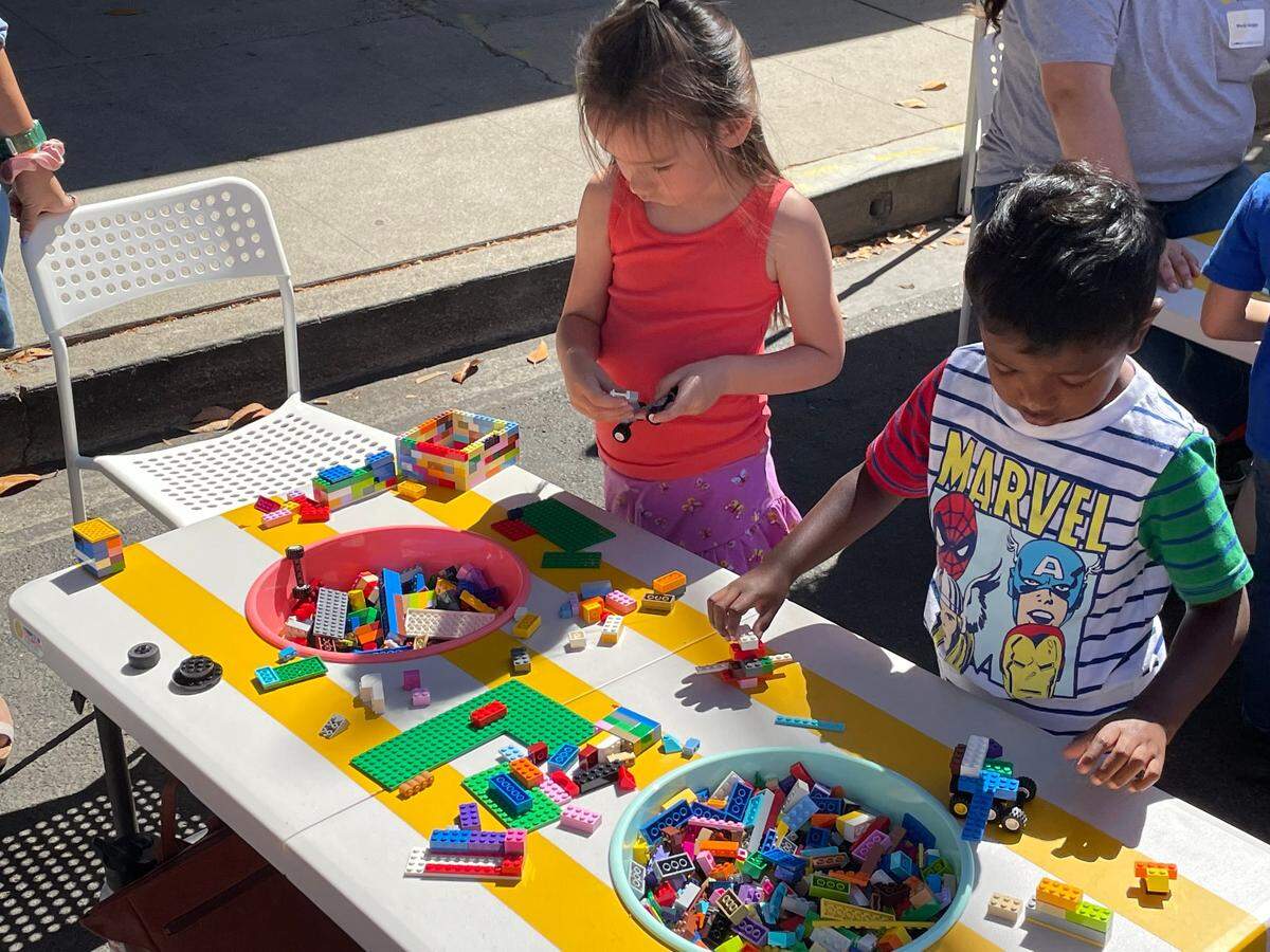 A building-block table and other activities lined 11th Street for the Modesto Children’s Museum’s Launch the Adventure festival downtown on Saturday, Aug. 13, 2022.