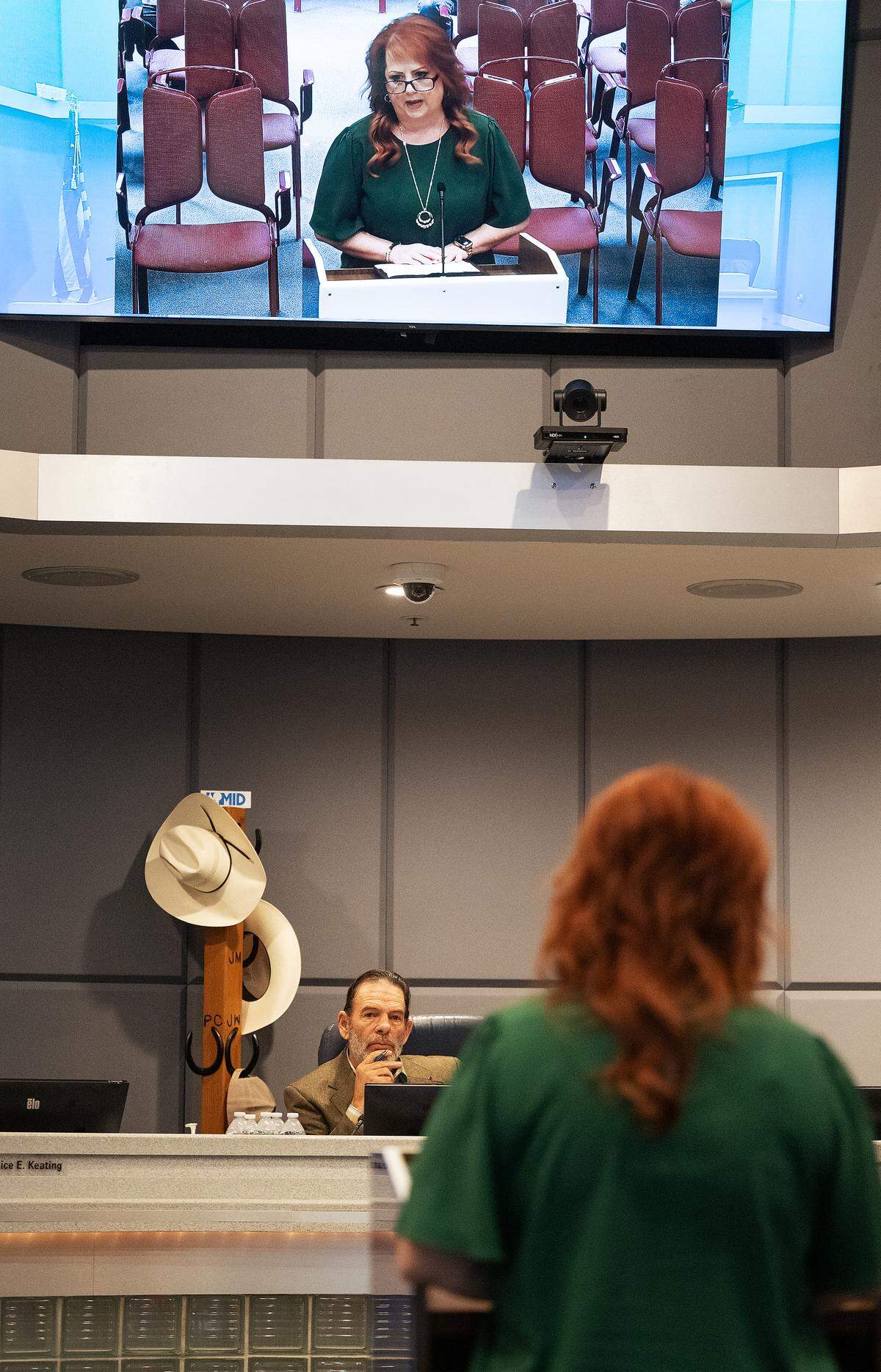 During public comment at the Modesto Irrigation District board meeting in Modesto, Tuesday, Aug. 12, 2025, board President Robert Frobose listens as Dana Ferreira, a regulatory analyst for MID, speaks about the alleged abuse by board member Janice Keating.