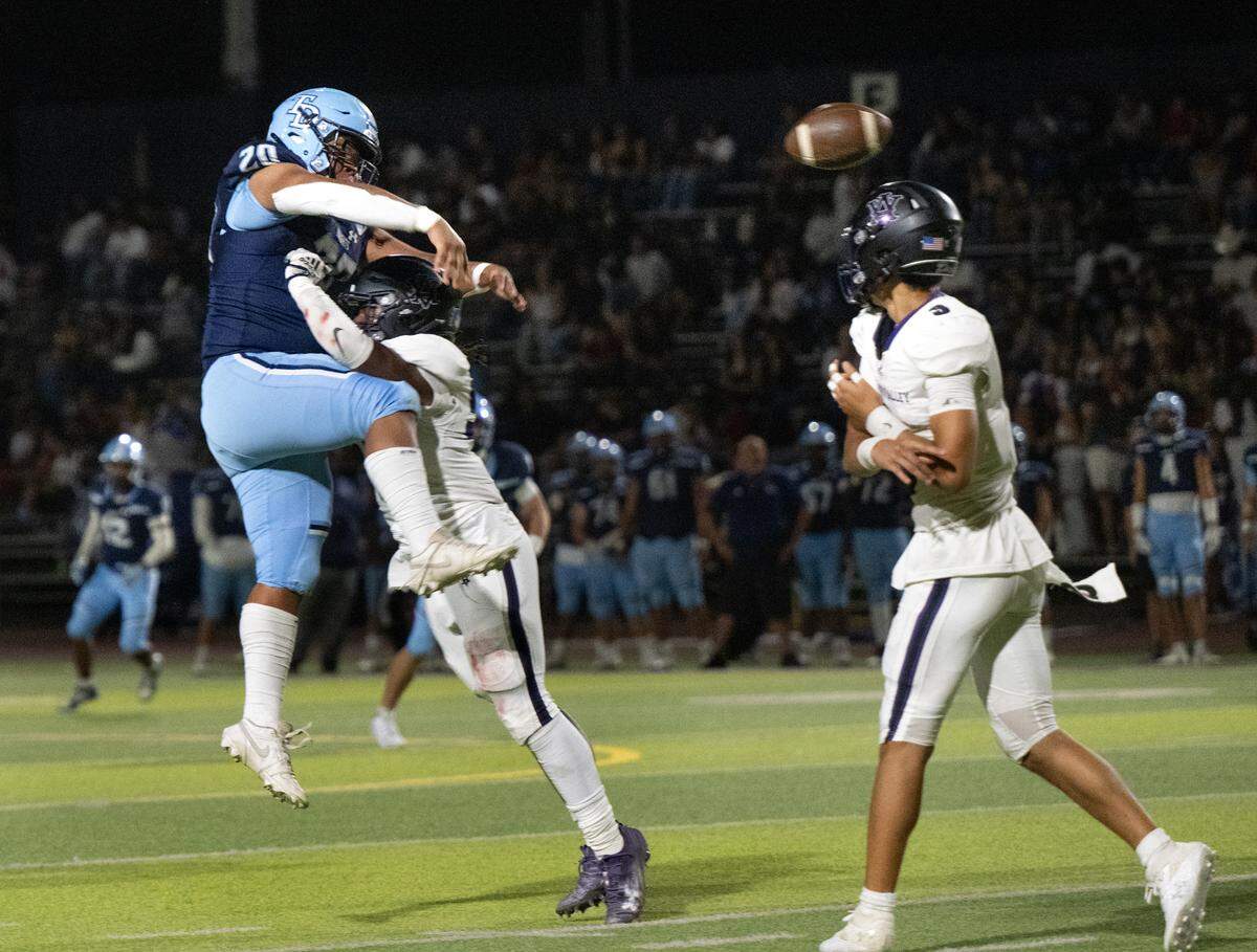 Downey’s Izzy Lopez (20) blocks the pass from Amador Valley quarterback Tristan Tia during the non-league game at Downey High School in Modesto, Calif., Friday, Sept. 13, 2024.