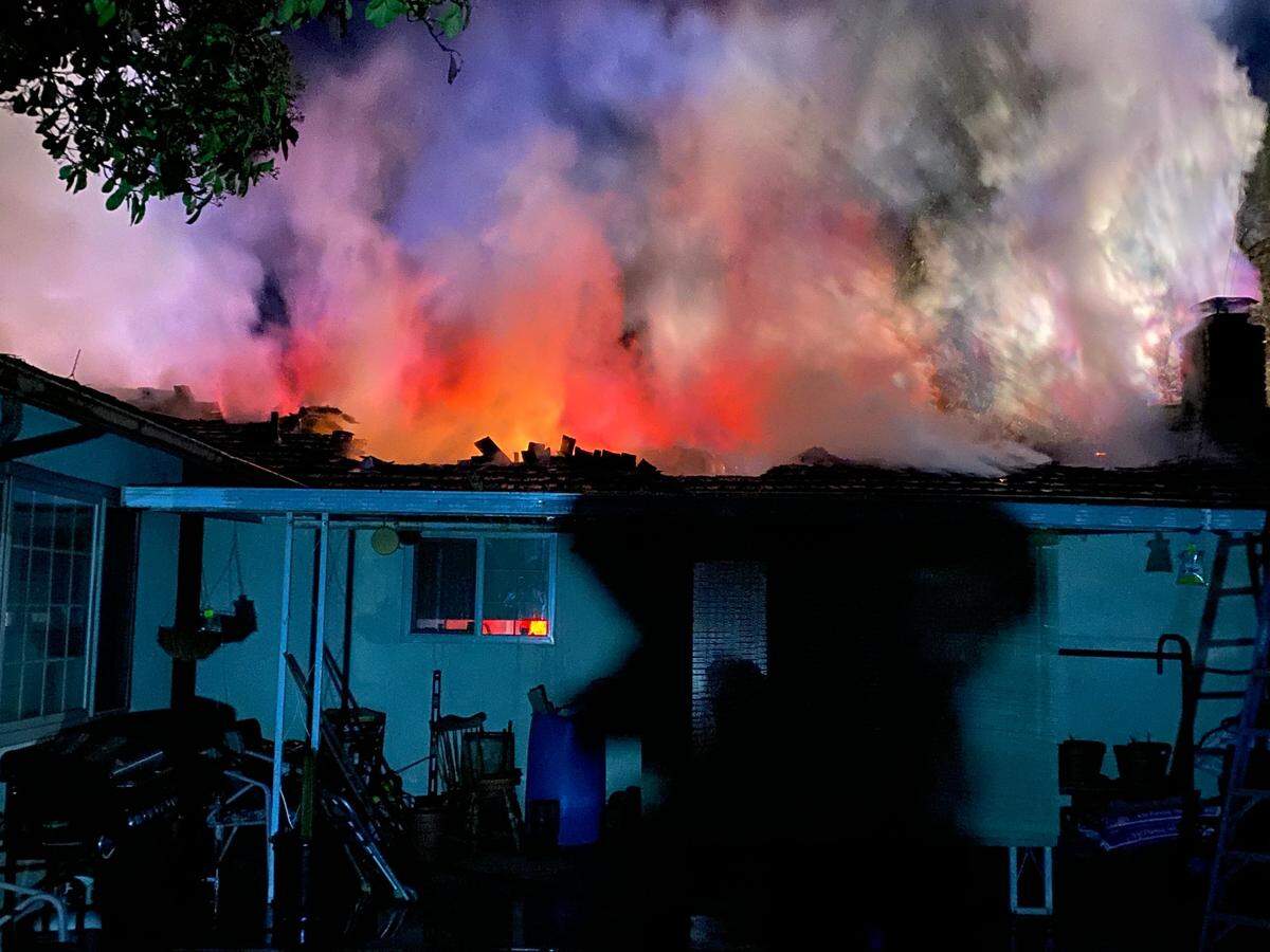 Fire destroyed the roof of a home on Stone Avenue between Oakdale and Knights Ferry on Saturday night, March 27, 2021, displacing two people.