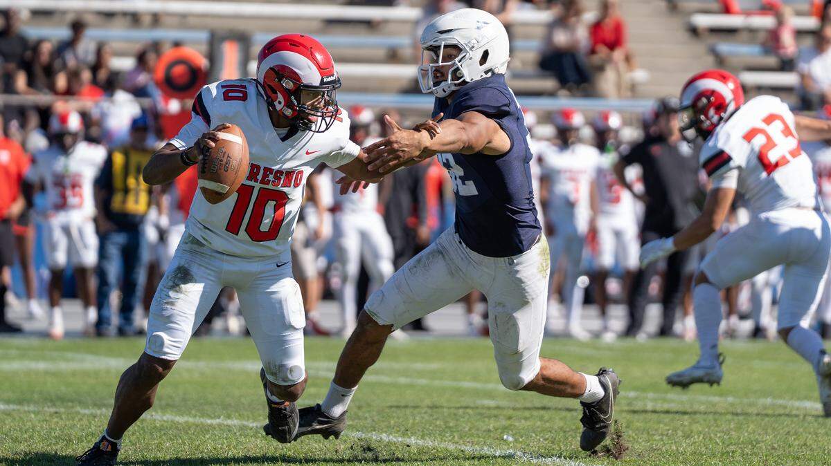 Modesto JC defensive lineman Jalonn Booth tries to sack Fresno City College quarterback Ya’j Vance during a Valley Conference game at Modesto Junior College in Modesto, Saturday, Oct. 11, 2025.