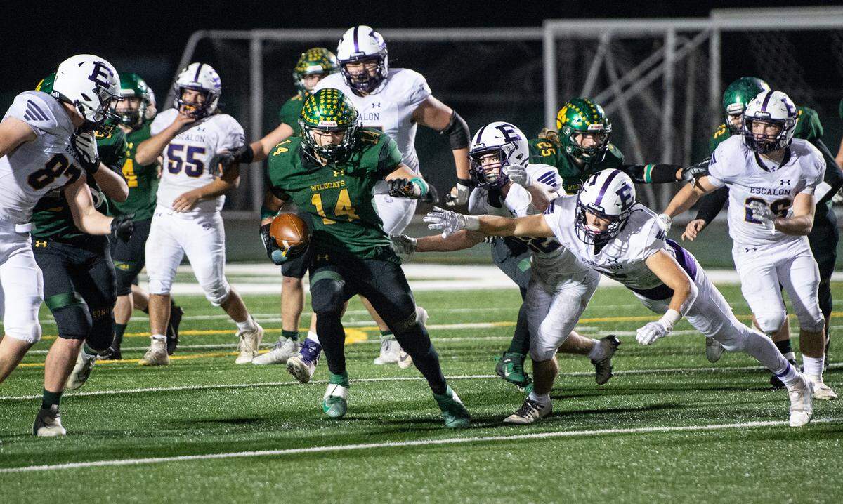 Sonora’s Bryce Nicolson breaks away from Escalon defenders for a touchdown during the Sac-Joaquin Section Division V championship game at St. Mary’s High School in Stockton, Calif., Saturday, Nov. 26, 2022.