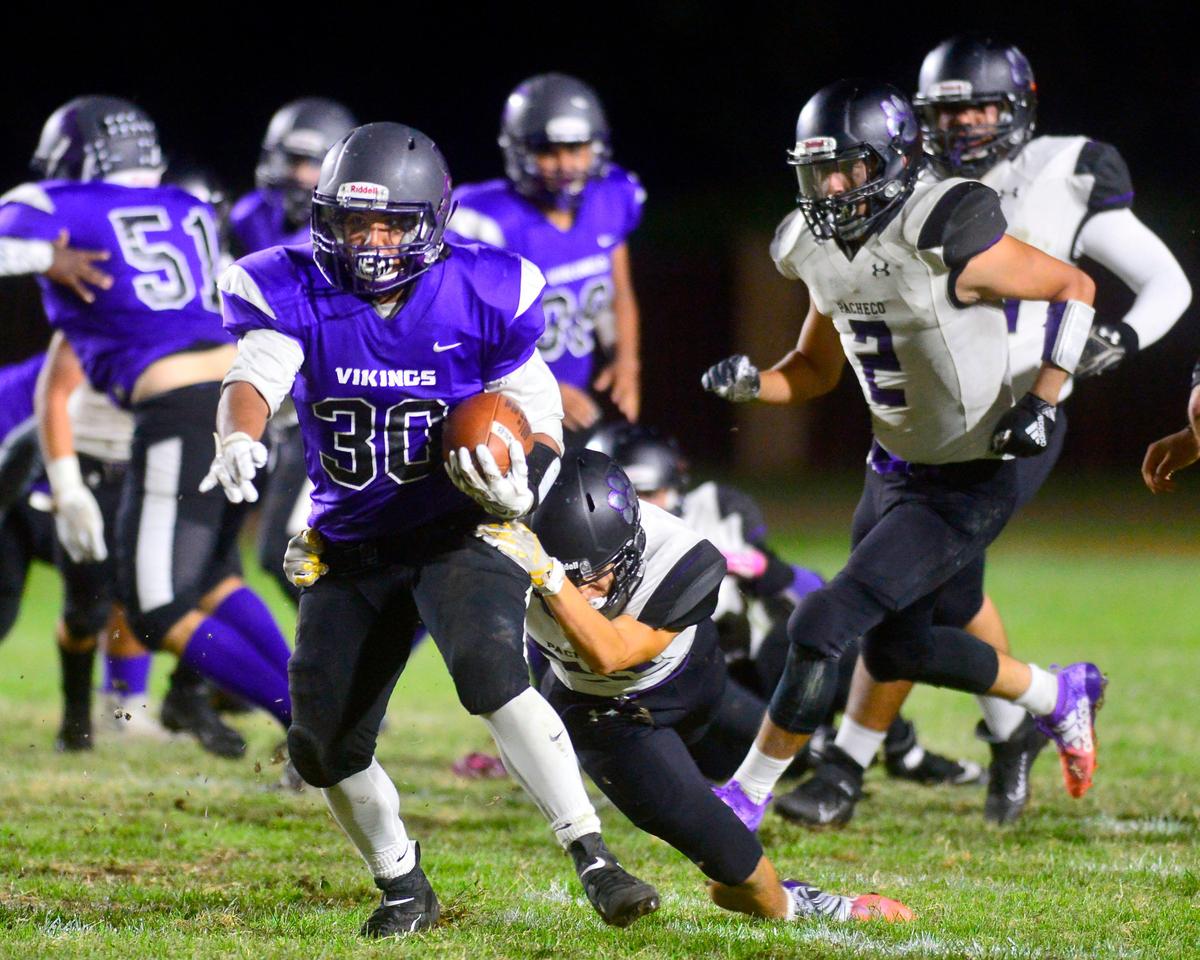 Johansen running back Jesse Arriola (30) runs thru an arm tackle during a game between Johansen High School and Pacheco High School at Johansen High School in Modesto California on September 20, 2019.