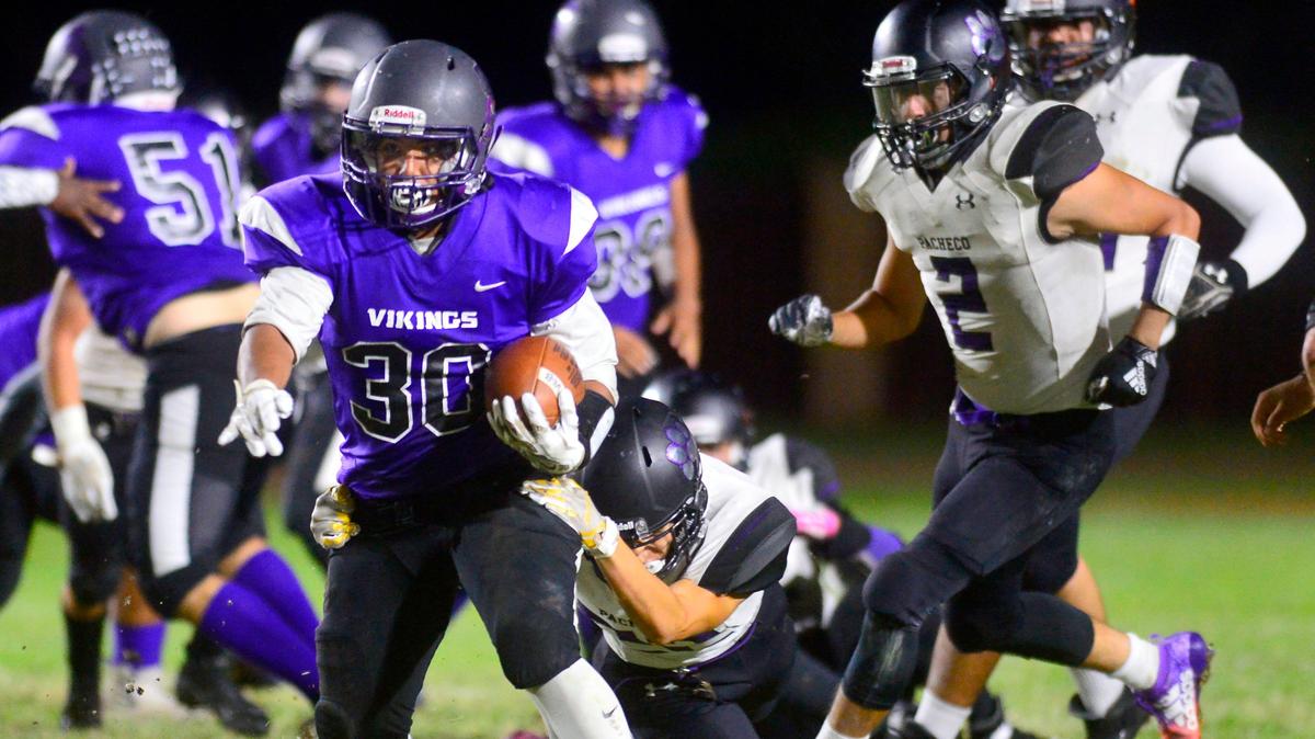 Johansen running back Jesse Arriola (30) runs thru an arm tackle during a game between Johansen High School and Pacheco High School at Johansen High School in Modesto California on September 20, 2019.