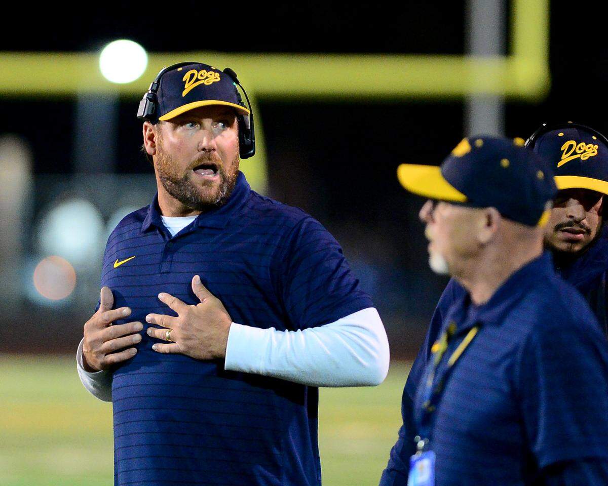 Turlock Head Coach James Peterson talks with his coaches during the game with Pitman at Turlock High School in Turlock, Oct. 17, 2025.