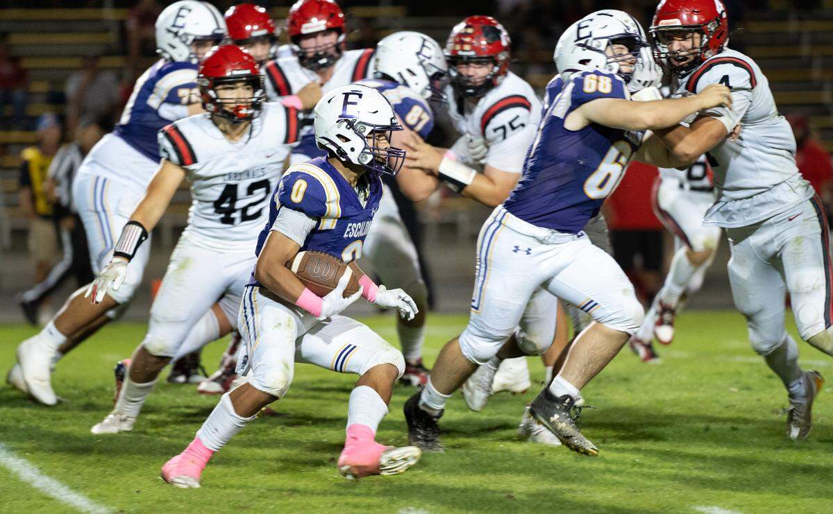 Escalon’s Ben Gonzalez runs past the line of scrimmage during a non-league game against Woodland Christian at Escalon High School on Thursday, Oct. 10, 2024.