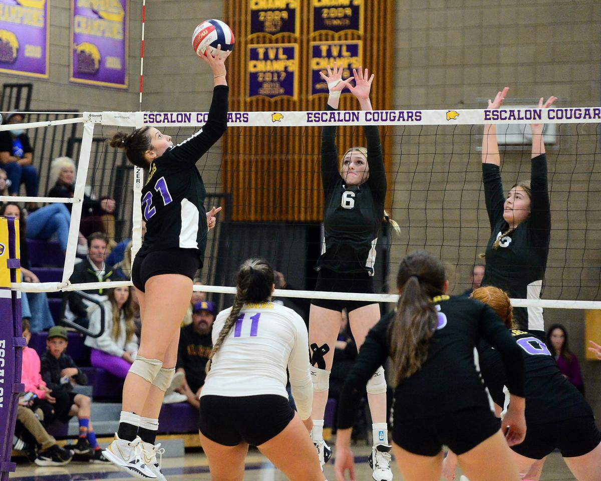 Escalon’s Carsyn Hood (21) lifts the ball over defenders during a CIF San-Joaquin Division III Girls Volleyball Playoffs game between Escalon High School and Ponderosa High School at Escalon High School in Escalon CA on November 1, 2022. Escalon won the match 3-2.