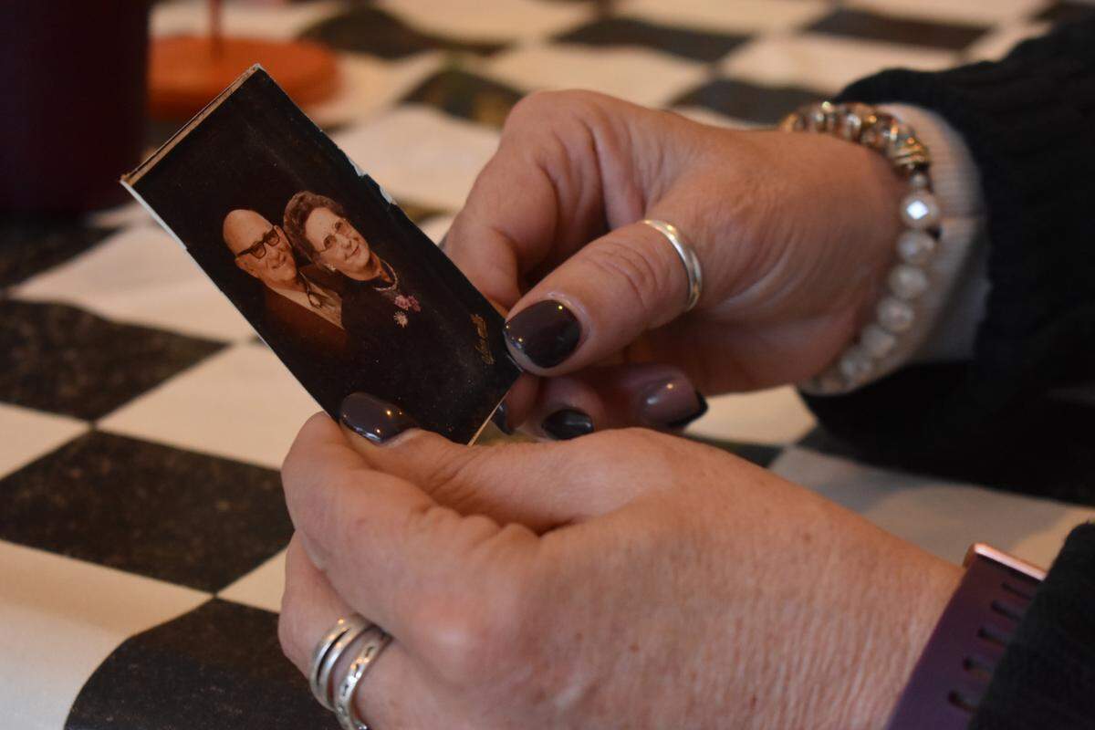 Lee Ann Bergwerff holds a photo of the parents of her father, Tony Cardoza, during a family lunch at Shorty’s Sports Pub & Grill in Escalon on Sunday, Nov. 24, 2019.