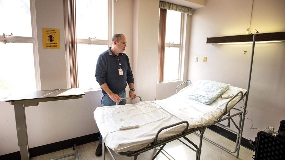 In this April 8, 2020, photo, Stanislaus County Facilities Manager Matt Innes shows the beds been set up at the former County Hospital on Scenic Avenue in Modesto to care for COVID-19 and non-coronavirus patients if needed.