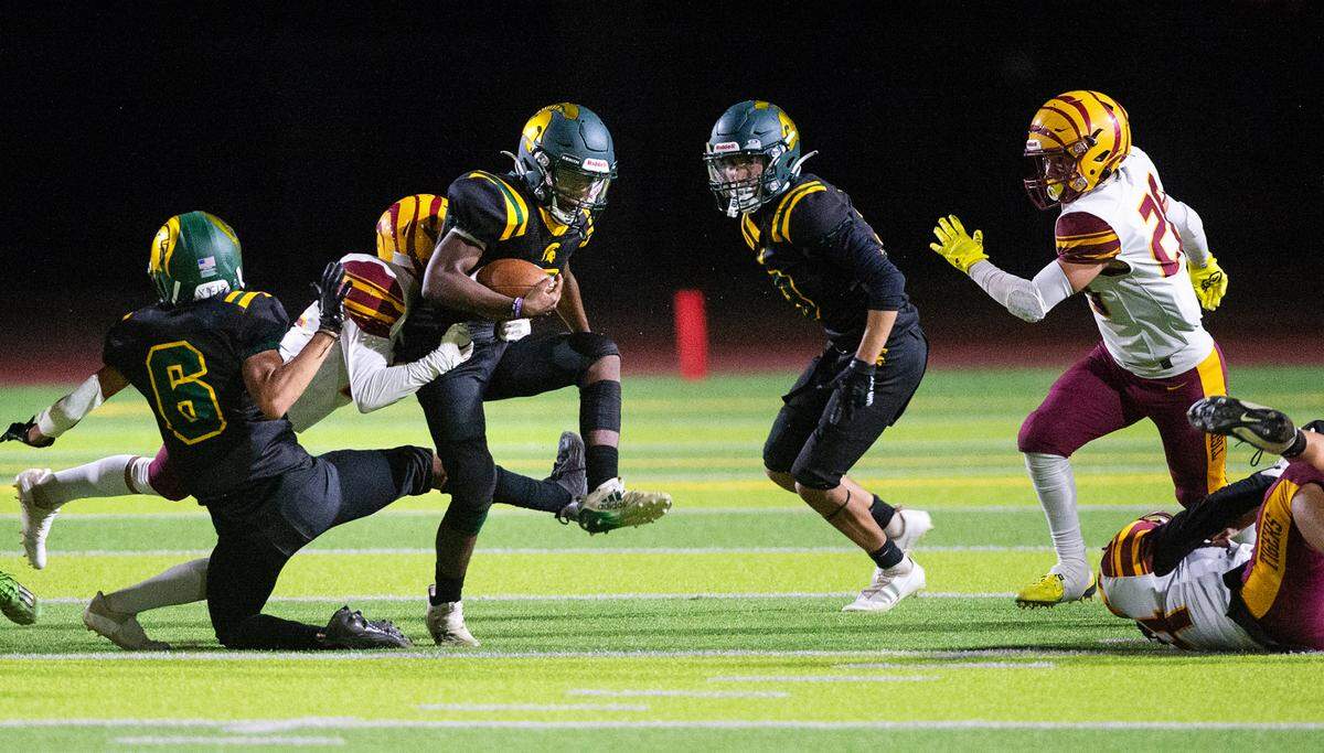 Los Banos’ Isaiah Medina tackles Davis runner Darnell Jackson during a Western Athletic Conference game at Downey High School in Modesto, Calif., on Friday, September 23, 2022. Los Banos won the game 32-17.