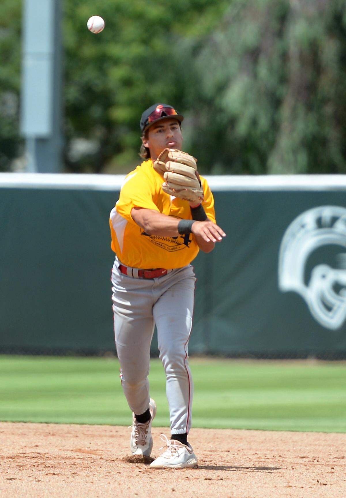 Oakdale High senior infielder Carlo Antinetti throws out a runner at first base during the 32nd Modesto Sunrise Rotary All-Star Game at CSU Stanislaus on Saturday, June 8, 2024.