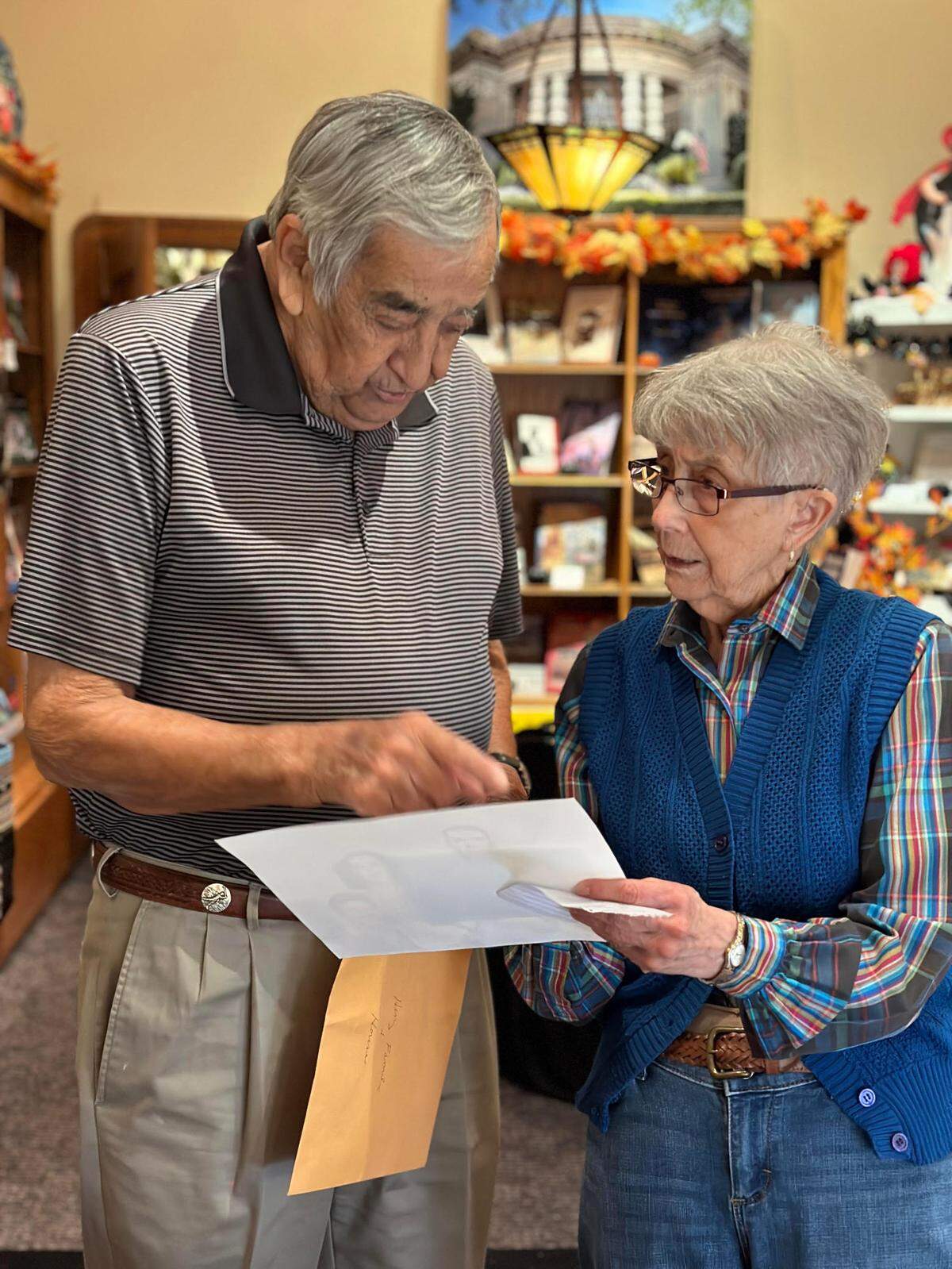 Janet Lancaster, right, helping helping Henry Solario in 2023.