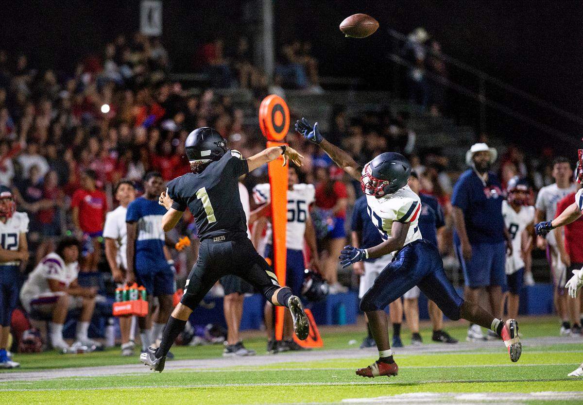 Enochs quarterback Adam Ammar throws a pass under pressure from Beyer’s Christopher Thomas during Friday’s game at Downey High School in Modesto, Calif., on August 19, 2022.