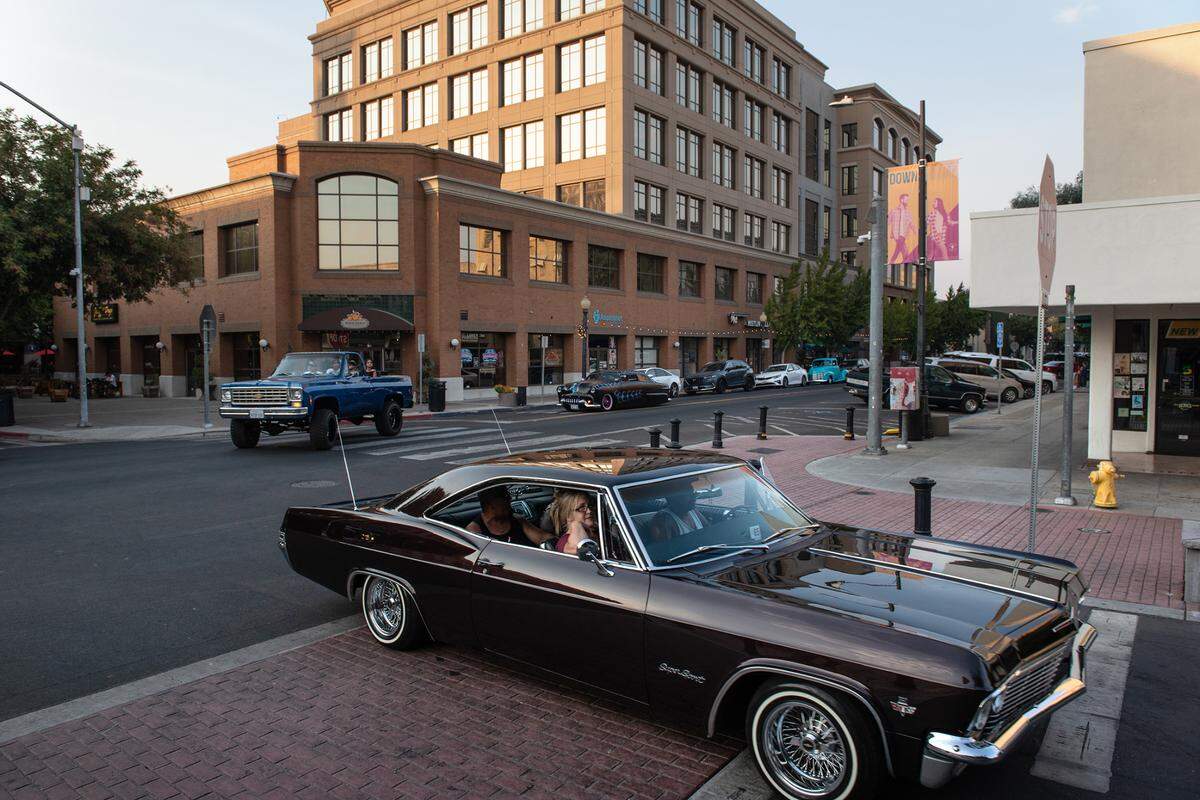 Members of car clubs cruise onto 10th Street during the Dia de Indepedencia Cruise in Modesto, Calif., on Friday, September 9, 2022.
