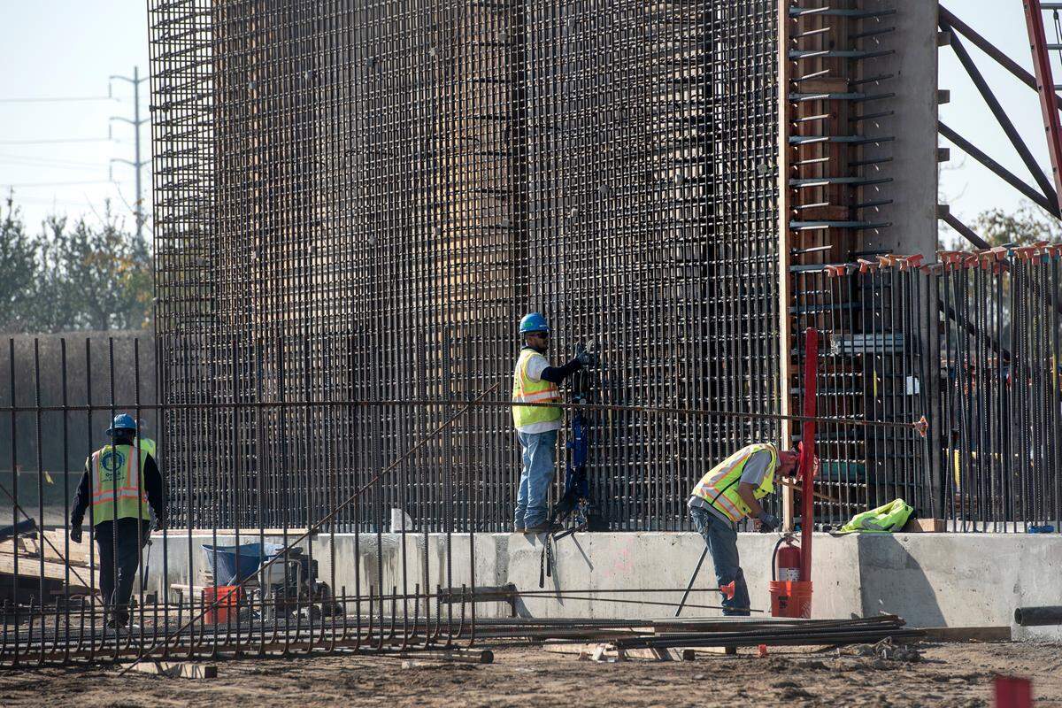 A crew works on the flocculation/sedimentation basin at the water treatment plant being built as part of the Regional Surface Water Supply Project near Hughson, Calif., Dec. 1, 2021.