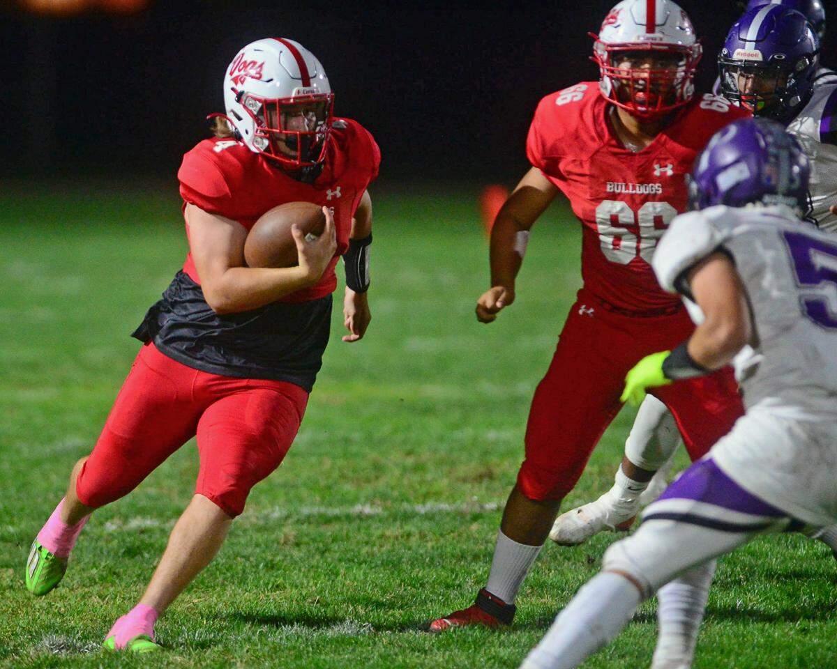 Ceres quarterback Landyn Hudson runs upfield during a game between Ceres High School and Pacheco High School at Ceres High School in Ceres California on October 7, 2022.