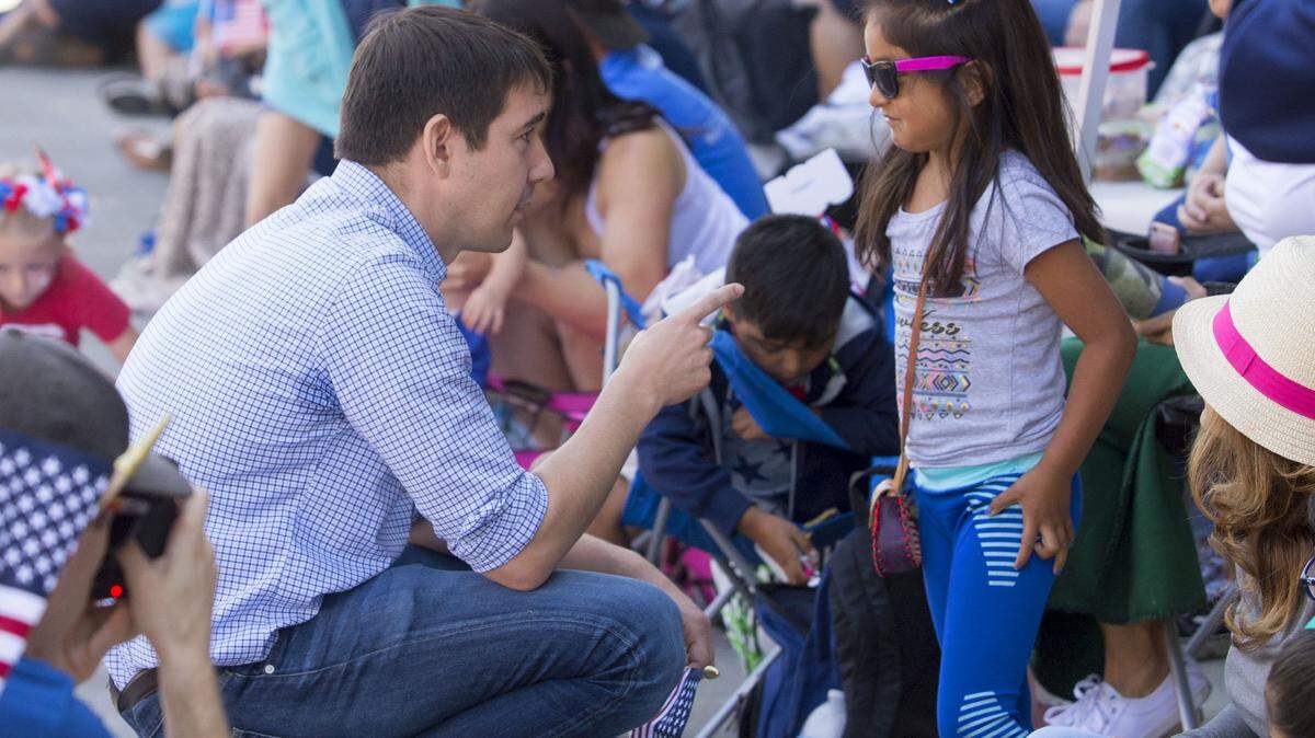 California’s 10th District Representative Josh Harder (left) talks with a young supporter, Marlen Pimentel age 6, at the Fourth of July Parade in downtown Modesto on July 4, 2019.