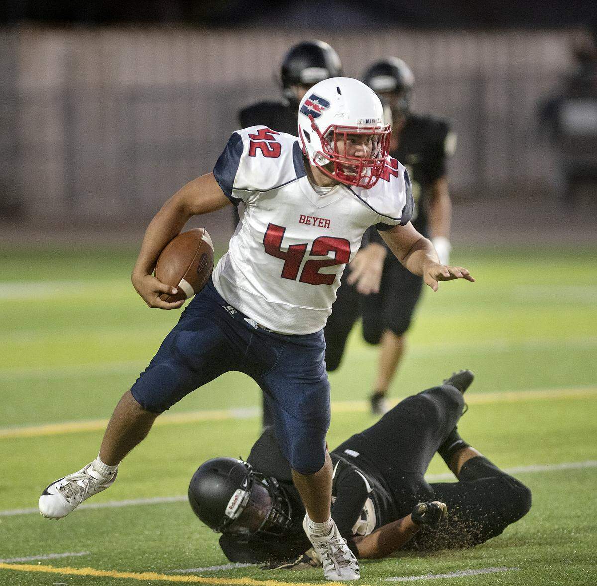 Beyer’s Sean Perkins runs the ball during the game with Enochs at Downey High School in Modesto, Calif., Friday, Aug. 23, 2019.
