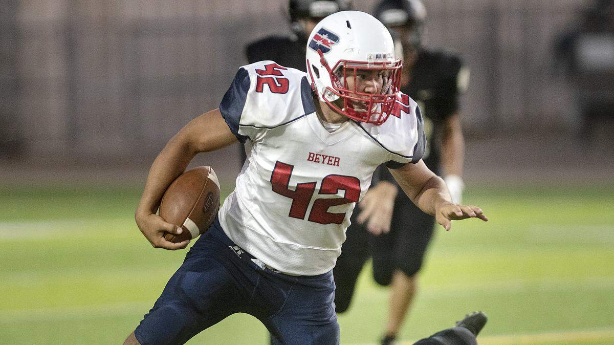 Beyer’s Sean Perkins runs the ball during the game with Enochs at Downey High School in Modesto, Calif., Friday, Aug. 23, 2019.