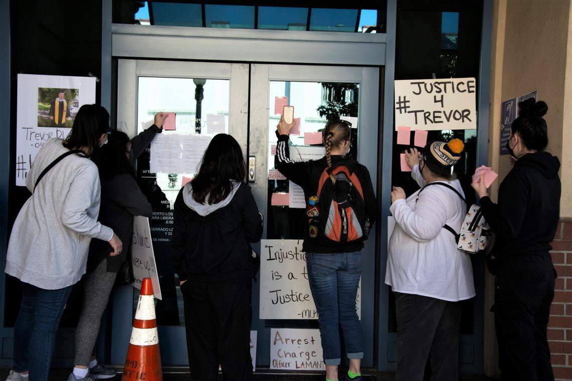 Protestors post messages on the entrance of the Modesto Police Department against the fatal police shooting of Trevor Seever, who was unarmed, in Modesto, Calif, Jan. 9, 2021.