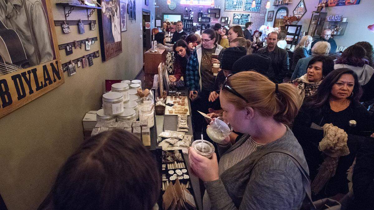 Shoppers browse handmade items at Deva Cafe during Mod Shop in Modesto, Calif., on Nov. 24, 2018. The Chamber of Commerce has created an e-commerce platform for crafters and makers to sell their wares.