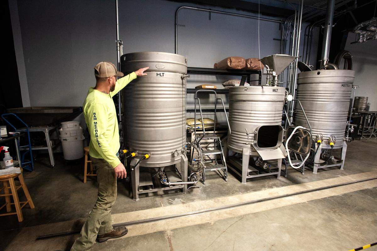 Co-owner and brewer Alan Atkins shows some of the brew tanks at Five Eye Brewing in Ceres, Calif., on Tuesday, Nov. 23, 2021.