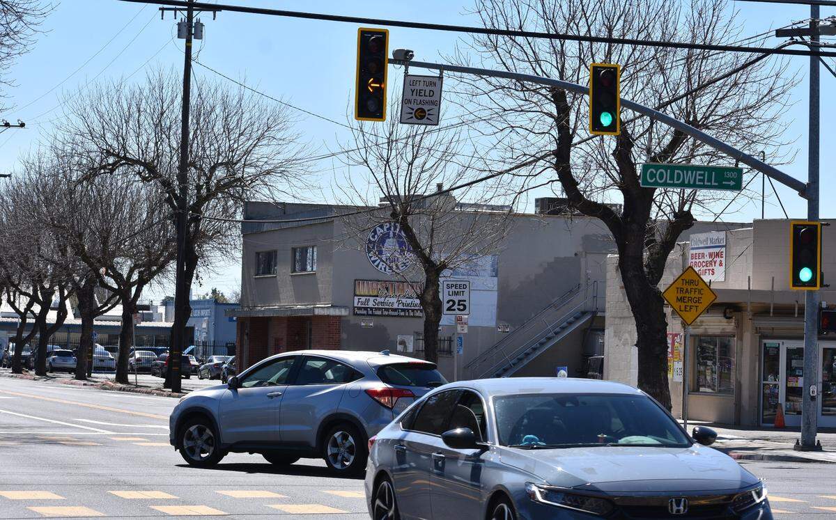 At one of the new yellow flashing turn lights, a driver enters the Modesto Junior College campus at the intersection of Tully Road and Coldwell Avenue on Thursday, March 14, 2024.
