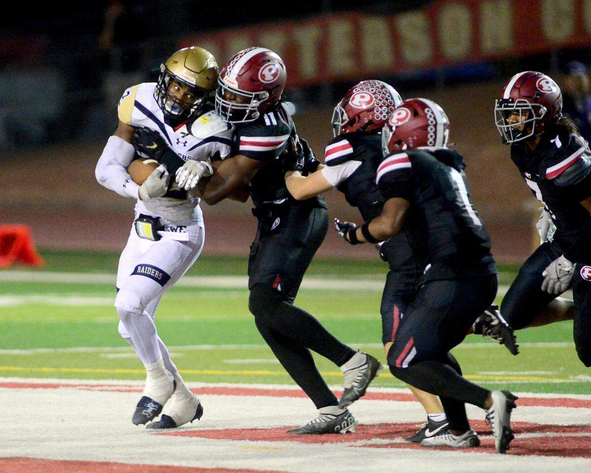 Central Catholic running back Joey Alcutt (12) fights for extra yards against multiple Patterson defenders during a game between Central Catholic High School and Patterson High School at Patterson High School in Patterson California on September 9, 2024. Central Catholic won the game 25-14