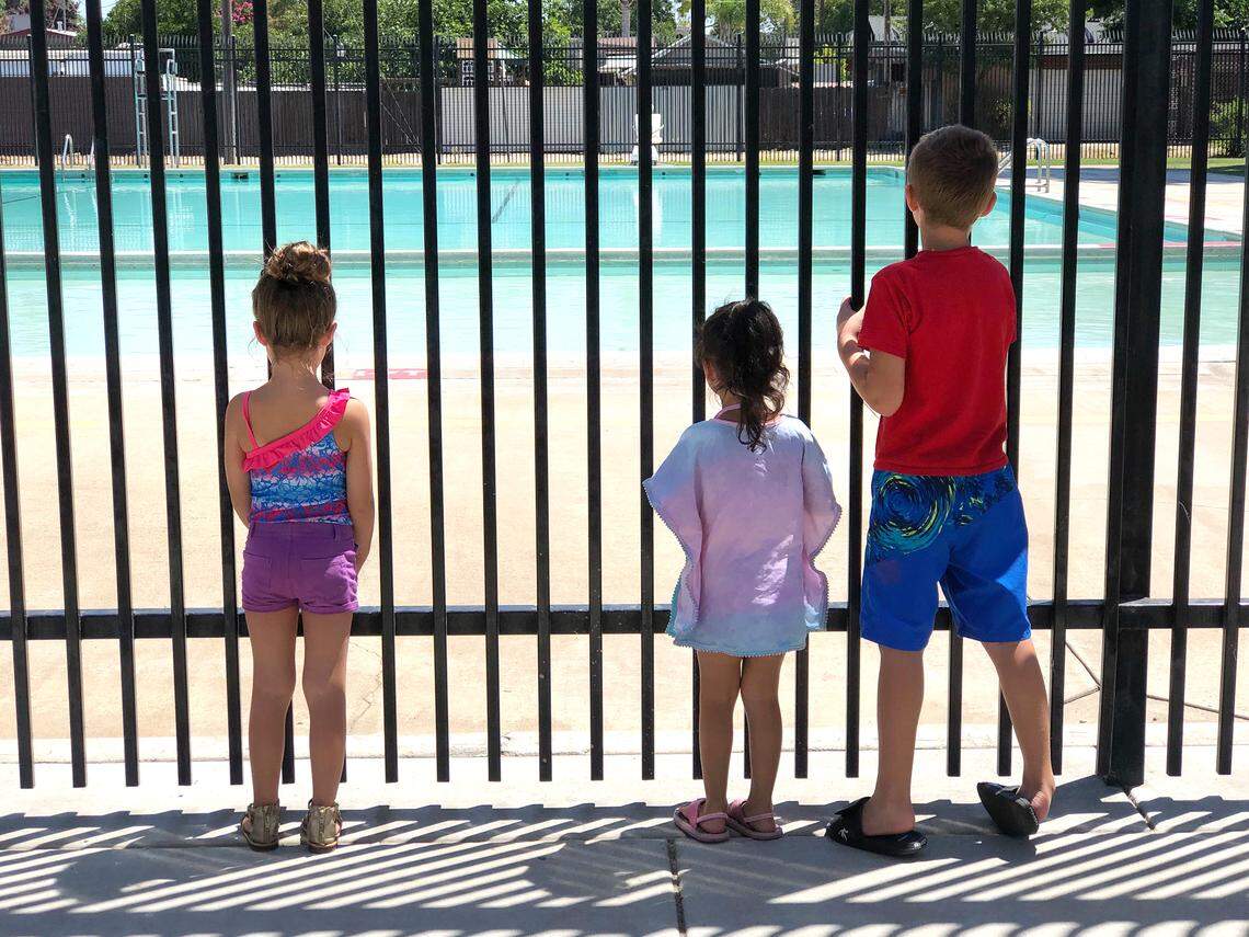 This file photo shows kids hoping to swim turned away at the community pool in Columbia Park in Turlock, Calif. on Aug 1, 2019.