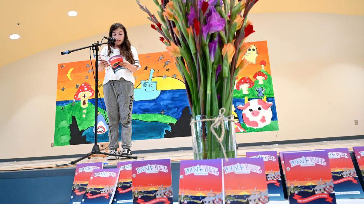 Fifth-grade student Dalilah Escamilla reads one of her poems from the book of poems “Poesia y Arte Curando el Alma/ Poetry & Art Healing the Soul” created during Modesto City School arts after-school program at Bret Harte Elementary School in Modesto, Calif., Wednesday, May 22, 2024.