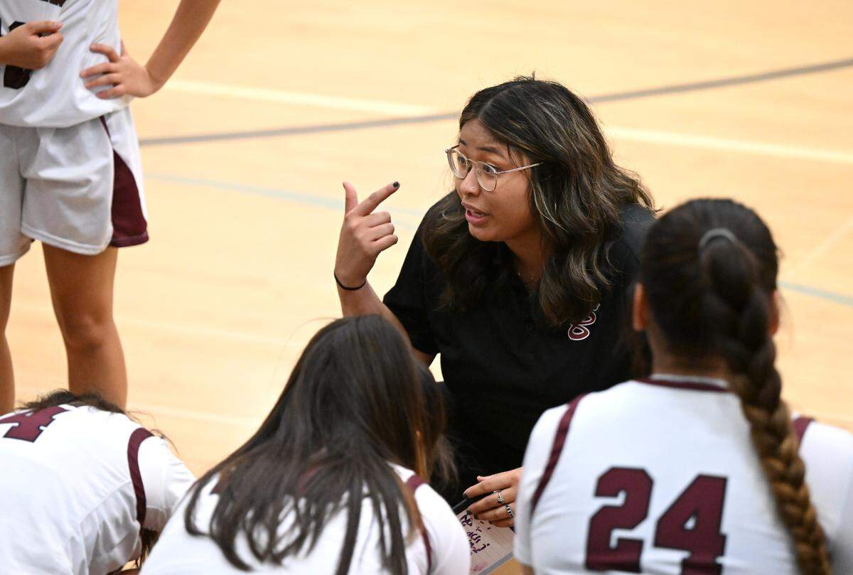 Riverbank coach Janelle Luu speaks with her players on a timeout during the Trans Valley League game with Escalon at Riverbank High School in Riverbank, Calif.,Thursday, Jan. 4, 2024. Escalon won the game 52-51.