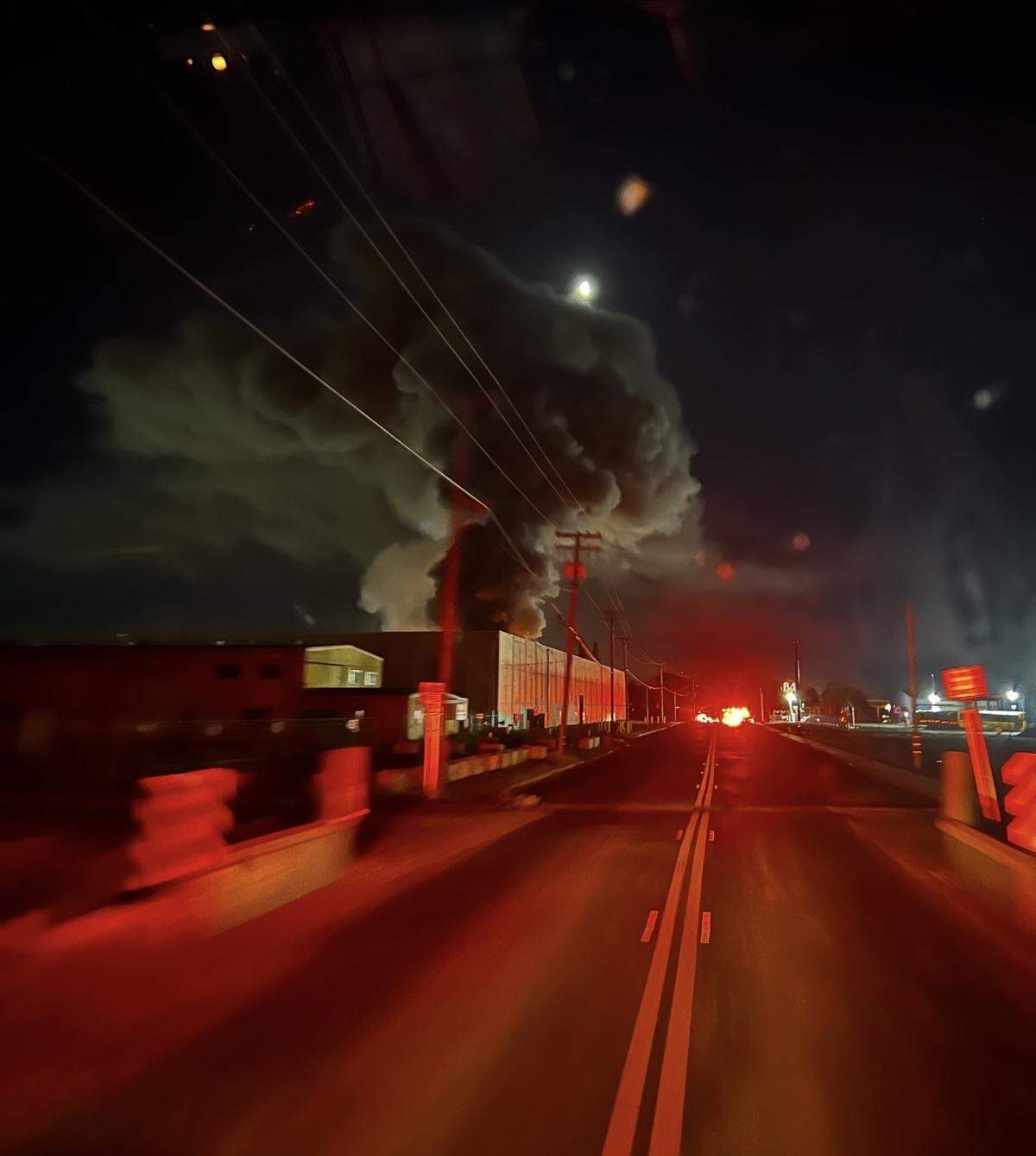 Smoke billows into the night sky as emergency crews respond to a structure fire along Beard Avenue in Modesto.