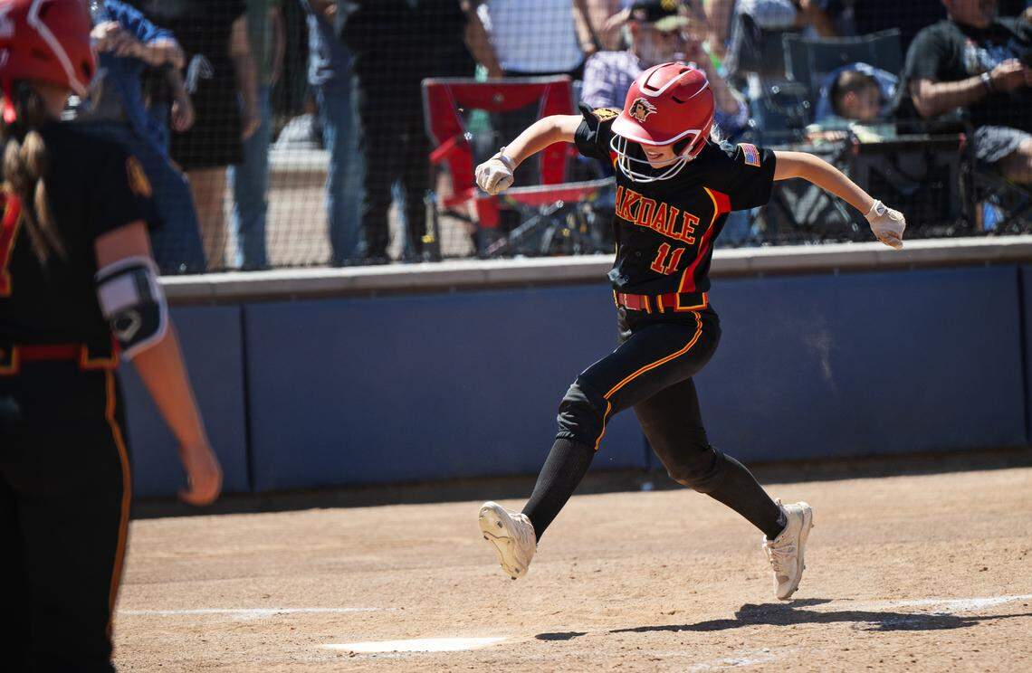 Oakdale’s Bailey Peterson crosses the plate as part of a three-run 8th inning during the Sac-Joaquin Section D III softball championship game with Capital Christian at Cosumnes River College in Sacramento, Calif., Saturday, May 25, 2024. Oakdale won the game 3-2.