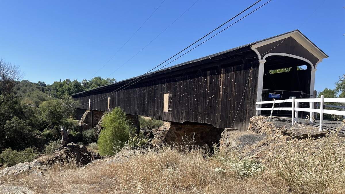 The covered bridge across the Stanislaus River in Knights Ferry is not expected to reopen for several years. Photographed June 14, 2026.
