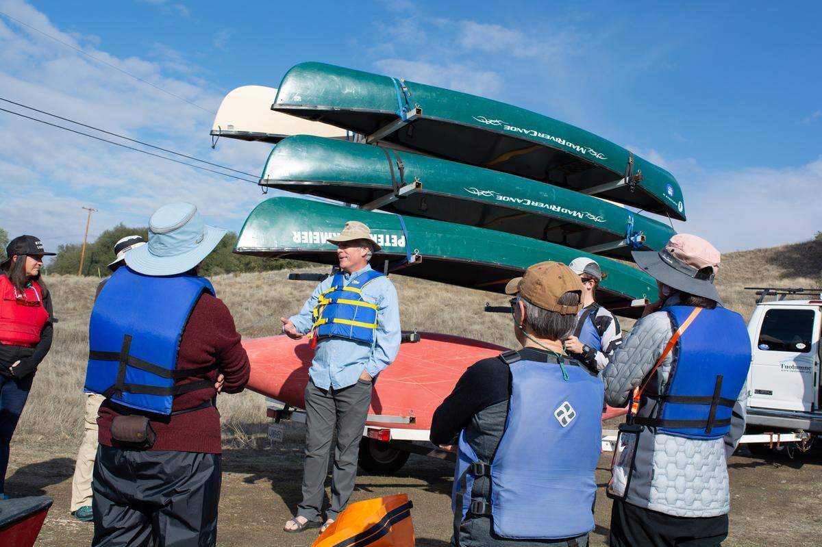 Peter Drekmeier, center, policy director for the Tuolumne River Trust, speaks to supporters about to observe salmon spawning on Nov. 12, 2022, near La Grange CA.