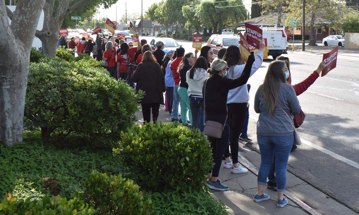 Nurses rally along Orangeburg Avenue in front of Doctors Medical Center on Wednesday, April 27, 2022, to share the message that understaffing isn’t safe for patients. A music system played a steady stream of songs, including at one point “Bad Medicine” by Bon Jovi.